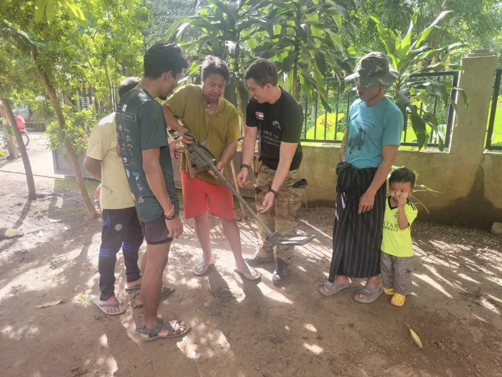 Field instructor demonstrating landmine detection and clearance techniques to local volunteers in Myanmar.